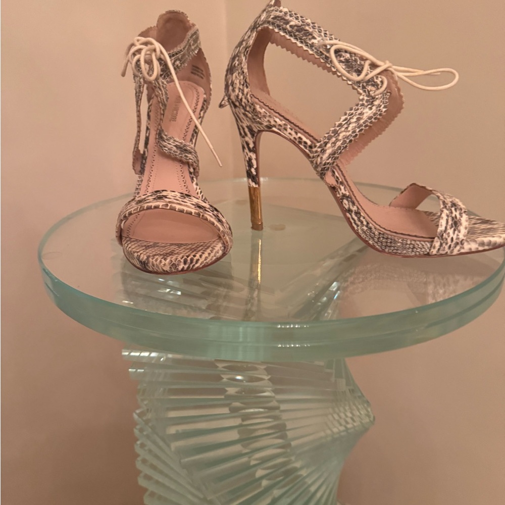 A pair of night heel leather snake skin sandals size 8.5